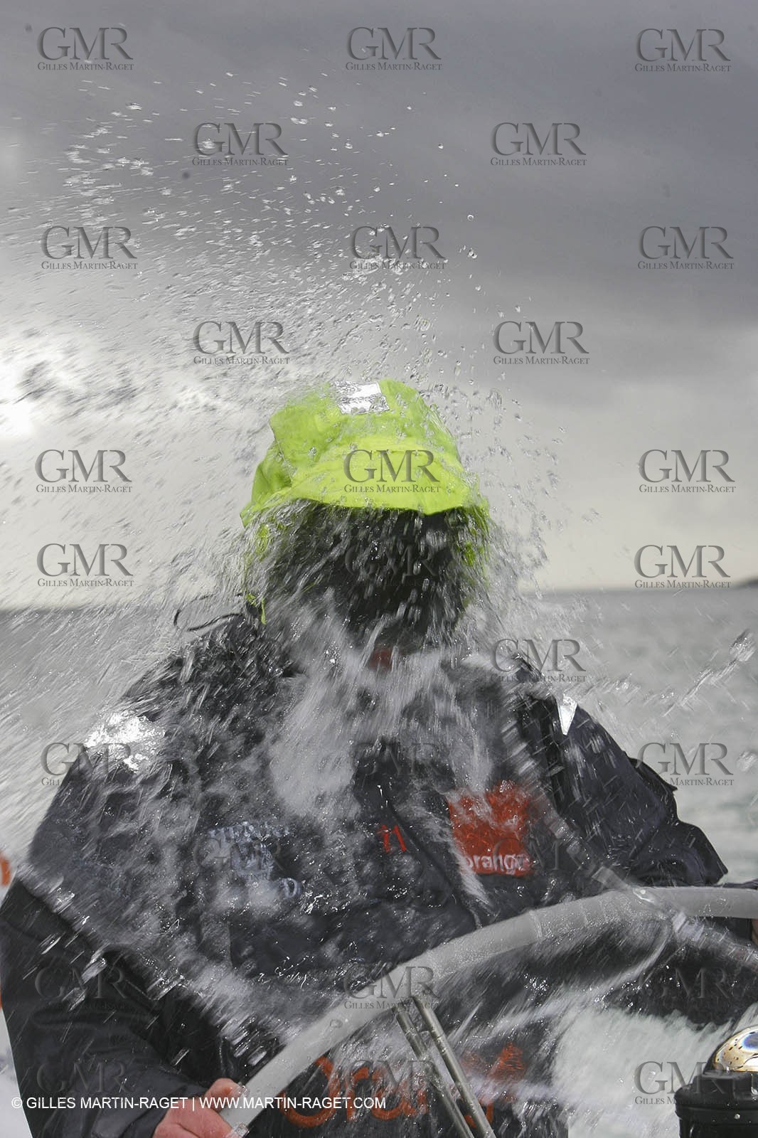 Orange II  - 2005 Jules Verne Trophy - Training in Bay of Biscay - Lionel Lemonchois + helmsan strong wind helmett-