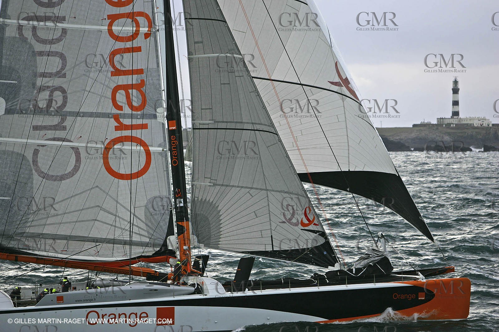 Orange II-2005 Jules Verne Trophy-Orange II and Bruno Peyron cross the starting line in front of the Ushant ligthhouse